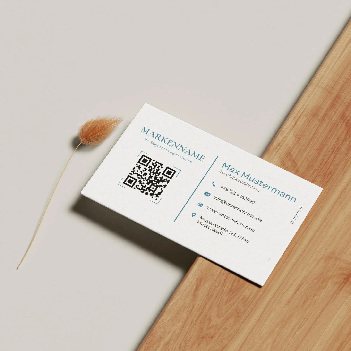 Moderne Visitenkarten Vorlage mit QR-Code und Logo in Weiß-Blau auf heller Holzoberfläche, vollständig personalisierbar in Canva – Louvion.de